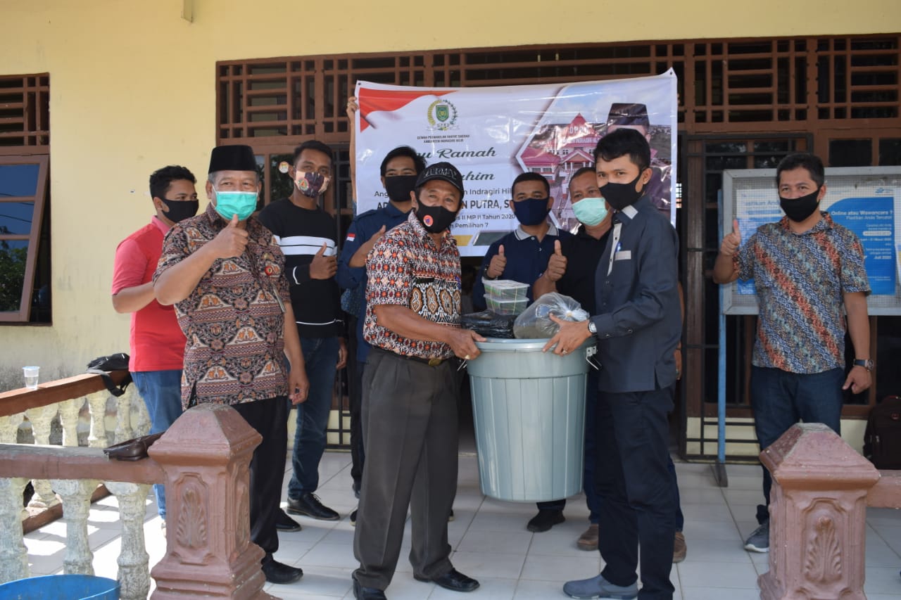 Anggota DPRD Inhil, Adhitya Ramadhan Putra, ST menyerahkan bantuan peralatan budidaya ikan dalam ember.
